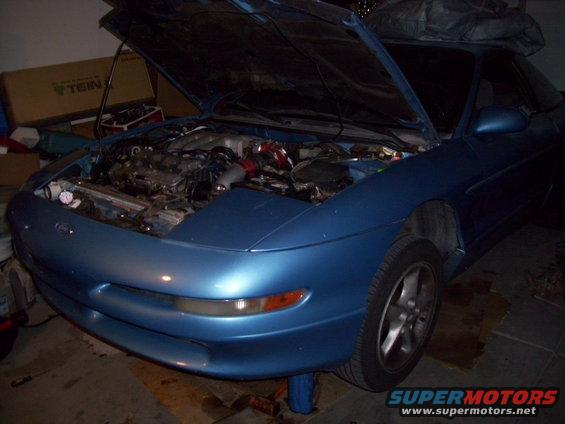 Blue 1993 Ford Probe with hood open, showing engine bay