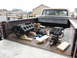 1979 Ford F-150 - Engine components are transported in the bed of a pickup truck.