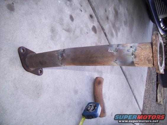 exhaust pipe with welds and a tape measure