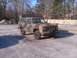 1994 Ford F-250 - This SUV, likely from the 1980s, is painted in a camouflage pattern and has a front end.