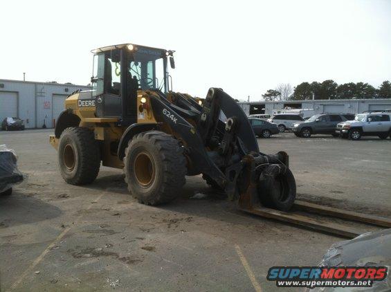 John Deere 624K wheel loader with forks in a lot
