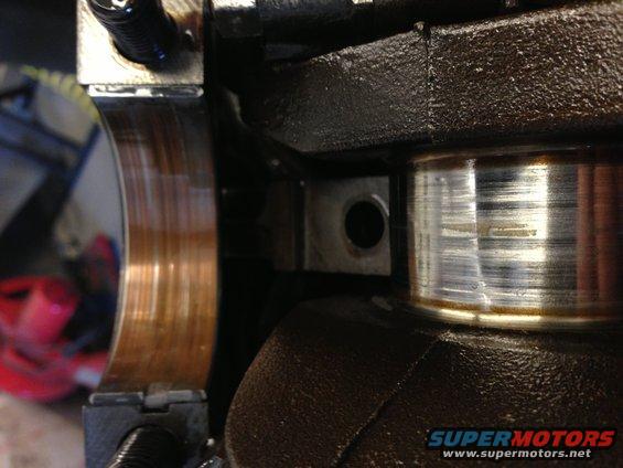 Close-up of engine crankshaft bearing with visible wear marks