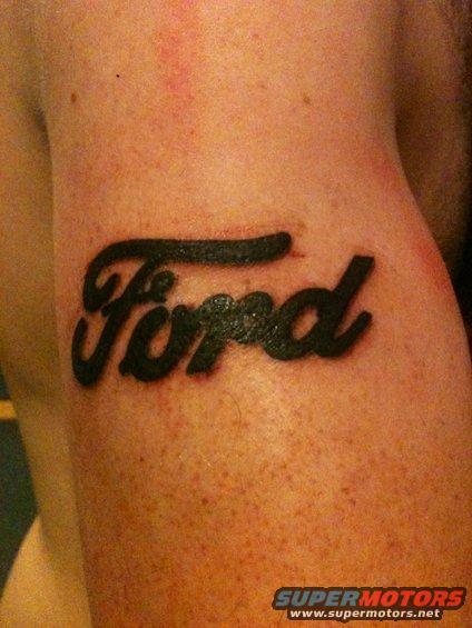 Black Ford script logo tattooed on skin