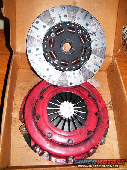 Clutch disc and red pressure plate in cardboard box