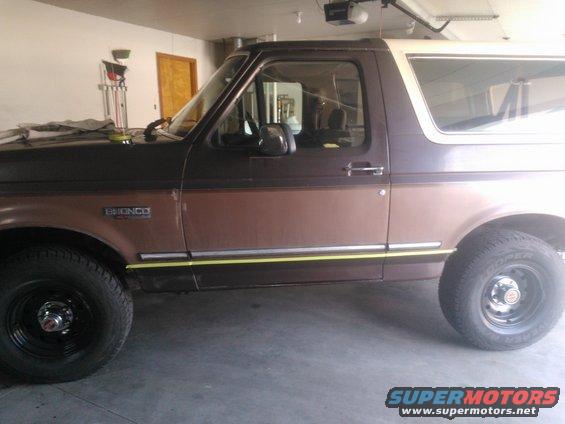 Brown and white 1992 Ford Bronco side view, showing two-tone paint and yellow trim