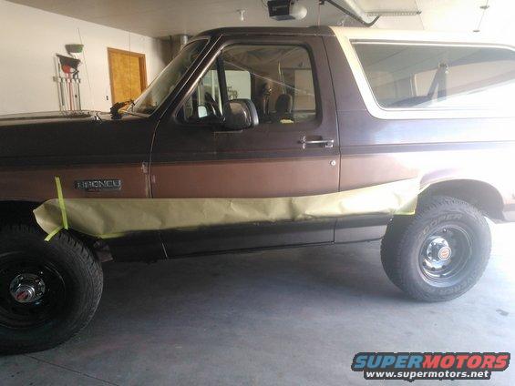 1992 Ford Bronco side view with masking tape on lower body