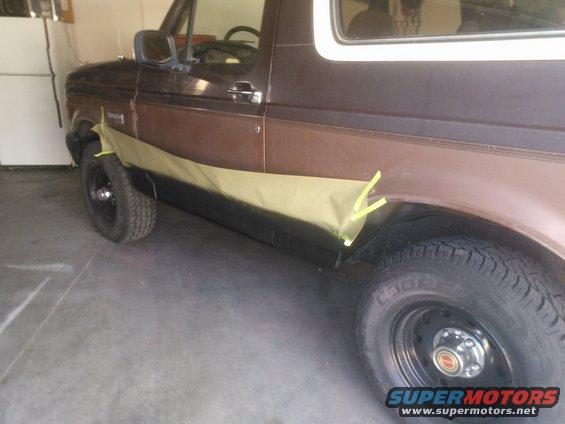 1992 Ford Bronco side panel with masking tape applied for painting