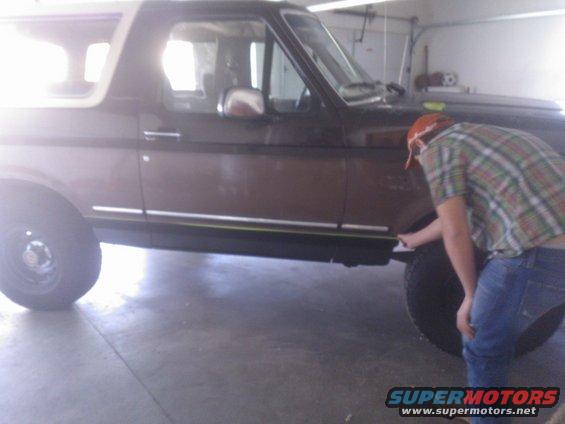 Side view of a brown 1992 Ford Bronco with a white top