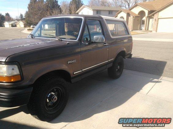 Brown 1992 Ford Bronco parked on a driveway, front 3/4 view