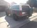 1992 Ford Bronco - This 1992 Ford Bronco is shown in a 3/4 rear view, its distinctive brown and white paint scheme and a spare tire mounted on the tailgate.