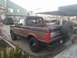 1992 Ford Bronco - This 1992 Ford Bronco is parked in a lot with other vehicles visible.