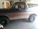1992 Ford Bronco - Side view of a 1992 Ford Bronco, its distinctive body style and trim details.