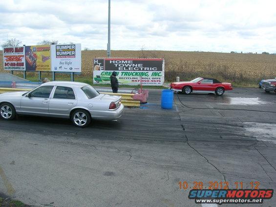 Silver 2003 Ford Crown Victoria sedan on drag strip, side view