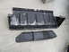 1994 Jeep Cherokee - Two black metal underbody skid plates are shown on a concrete surface.