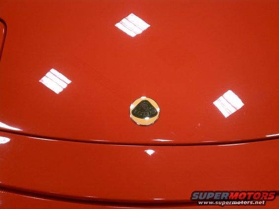 Lotus emblem on red car hood