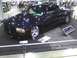 2003 Ford Crown Victoria - A custom pickup truck is displayed indoors with a "Lowkota" sign and other items on a mat.