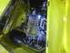 2003 Ford Crown Victoria - The engine bay of a yellow vehicle displays custom chrome parts and blue accents.