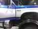 2003 Ford Crown Victoria - A blue and white Ford F-350 truck is shown from the side, with a focus on the door and fender area.