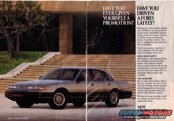Silver 1991 Ford Crown Victoria sedan parked on pavement in front of a building with stairs