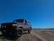 1992 Ford Bronco - Ford Bronco navigates a dusty trail on a clear day.