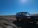 1992 Ford Bronco - This Ford Bronco is parked on a dusty, off-road trail with a clear blue sky overhead.