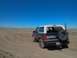 1992 Ford Bronco - This 1992 Ford Bronco is seen from a rear three-quarter view on a dusty trail with a spare tire mounted on the back.