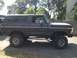 1979 Ford Bronco - Side view of a lifted 1978 Ford Bronco with custom wheels and running boards.