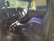 1979 Ford Bronco - The interior of a classic truck features a custom seat cover and aftermarket gauges mounted on the dashboard.