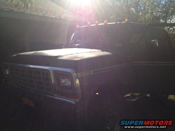 1979 Ford Bronco grille and front fender, dark color, sun glare