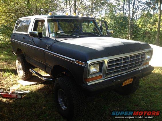 Dark blue and white 1979 Ford Bronco 3/4 front view with chrome trim and running boards