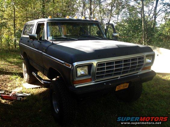 Black 1978 Ford Bronco with chrome grille and running boards parked outdoors