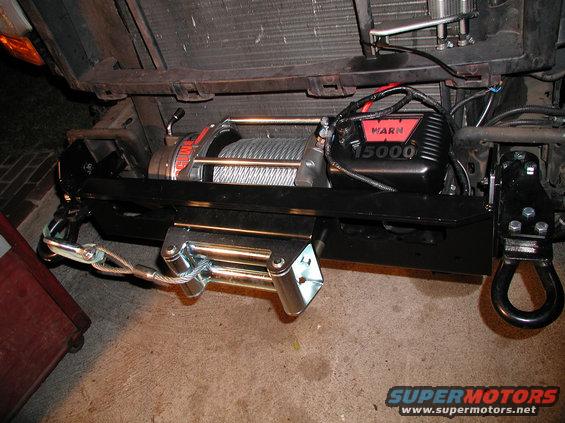 warnbumper6.jpg Winch tray is completely assembled with winch completed and operational.  I had to undo the tow hooks to put the bumper on because they must zigzag past the bumper bracket and then come out of the hole in the front of the bumper.  It is also easier to mount bumper by accessing tow hook holes.