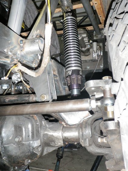Close-up of a vehicle's custom suspension with a coilover shock and linkage