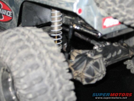 Close-up of off-road suspension and large tire with "Performance" sticker