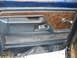 1993 Ford F-150 - Close-up of a worn car door panel, showing wood grain accents and a chrome window crank.