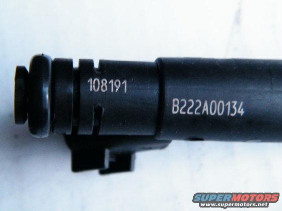 Close-up of a black fuel injector with part numbers 108191 and B222A00134 stamped on it