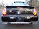 2002 Chevrolet Monte Carlo - Rear view of a black 2002 Chevrolet Monte Carlo SS, showing its distinctive spoiler and dual exhaust pipes.