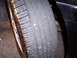 2002 Chevrolet Monte Carlo - A close-up view of a worn car tire, showing the tread pattern and sidewall markings.