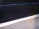 2002 Chevrolet Monte Carlo - Close-up of a black car door showing scratches and a silver trim piece along the bottom edge.