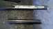1996 Ford Bronco - Close-up of metal parts on a workbench, possibly for automotive repair or fabrication.