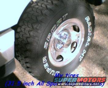 Truck tire with white lettering reading "SUPER SPORT RADIAL", chrome wheel, part of white body visible