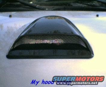 Aftermarket hood scoop mounted on a silver vehicle hood