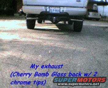 Silver Ford F-150 pickup truck rear view with dual chrome exhaust tips and a trailer hitch