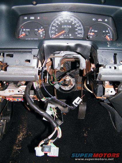 Dashboard wiring is exposed with steering column and pedals visible. Odometer shows 123788 miles