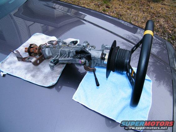 Steering column assembly and aftermarket steering wheel on car hood