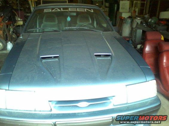 Blue car with Saleen windshield banner and hood scoops, front view