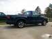 2000 GMC Sonoma - A dark blue 2000 GMC Sonoma pickup truck is parked on a concrete driveway next to another vehicle.