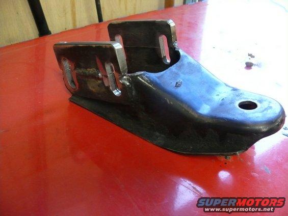 Metal bracket part on red surface