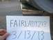 1996 Ford Bronco - A piece of paper with writing is held in front of a chrome exhaust tip.