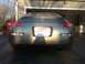 1996 Ford Bronco - The rear of a gray Nissan 350Z is shown parked in front of a garage.